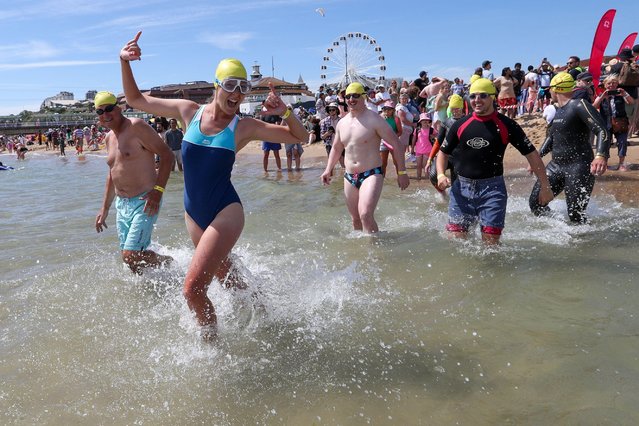 Swimmers take to the water at Bournemouth beach in Dorset for the annual Pier to Pier swim in aid of the British Heart Foundation on June 29, 2024. (Photo by Richard Crease/Alamy Live News)