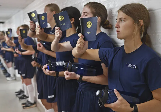Swab Cadet Langton reads the Running Light guidebook as members of the US Coast Guard academy class of 2026 report for the first day of Swab Summer, a seven-week training programme designed to transform civilian students into military members, in Connecticut on June 27, 2022. The Swabs, as the new cadets are called, cycle through haircuts, uniform issue, drill practice and various administrative in-processing over the course of the day. (Photo by Sean D. Elliot/AP Photo)