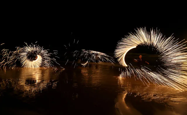 Palestinian boys play with fireworks as they celebrate the start of the Muslim holy month of Ramadan in Gaza City on Monday, June 30, 2014. Ramadan is traditionally a time of reflection and prayer,  to focus on spirituality, good deeds and charity. (Photo by Hatem Moussa/AP photo)