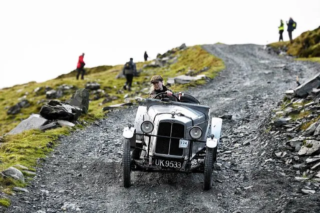 Alexandra Milne-Taylor drives an AJS 2 Seater Sports vintage car dating from 1930 as she takes part in the 52nd annual Lakeland Trial along a quarry road above Honister Slate Mine in Borrowdale, near Keswick, northern England on November 13, 2021. The event, run by the Vintage Sports-Car Club, is an untimed form of motorsport which takes place over several steep, rough and muddy Lake District hills. (Photo by Oli Scarff/AFP Photo)