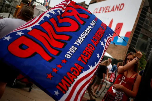 Danielle Nicolay, 14, a Donald Trump supporter, waves a flag with his name outside the gates of the Quicken Loans Arena, the site for the Republican National Convention in Cleveland, Ohio, U.S., July 21, 2016. (Photo by Adrees Latif/Reuters)