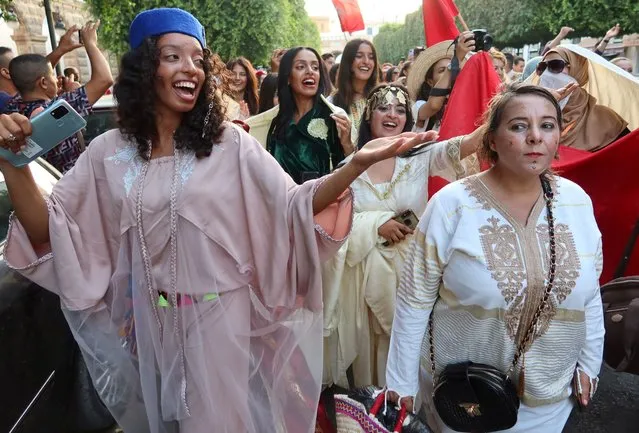 Women wearing traditional clothes gesture during a march to celebrate national women's day in Tunis, Tunisia on August 13, 2022. (Photo by Jihed Abidellaoui/Reuters)