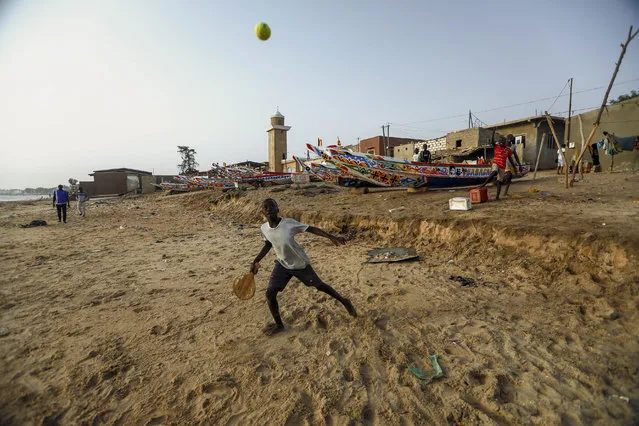 A boy plays tennis outside his house before the curfew, amid an outbreak of the coronavirus disease (COVID-19), in La Somone near Thies, Senegal on April 11 2020. (Photo by Zohra Bensemra/Reuters)