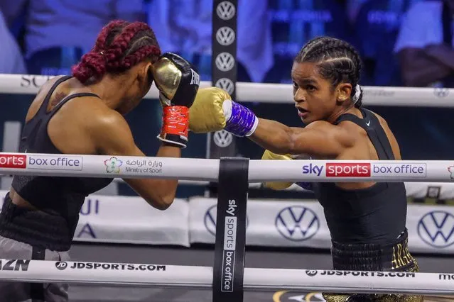 Somalia's Ramla Ali (R) competes with Dominican Crystal Nova during a super-bantamweight boxing match at the King Abdullah Sports City Arena in the Saudi Red Sea city of Jeddah, on August 20, 2022. (Photo by Giuseppe Cacace/AFP Photo)