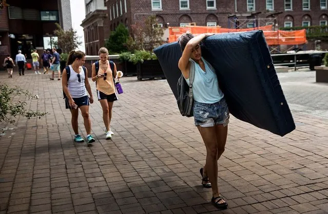 Emma Sulkowicz, a senior visual arts student at Columbia University, carries a mattress in protest of the university's lack of action after she reported being raped during her sophomore year, on September 5, 2014. Sulkowicz has said she is committed to carrying the mattress everywhere she goes until the university expels the rapist or he leaves. The protest is also doubling as her senior thesis project. (Photo by Andrew Burton/Getty Images)