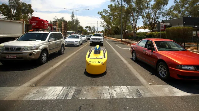 This handout from the World Solar Challenge 2017 taken and received on October 10, 2017 shows University of Michigan Solar Car Team vehicle “Novum” from the US arriving in Alice Springs on the third day of racing The World Solar Challenge, an epic 3,000- kilometre (1,860- mile) solar car race across outback Australia, has become one of the world’s foremost innovation challenges with teams looking to demonstrate designs that could one day lead to solar- powered cars for consumers that can carry passengers. (Photo by Mark Kolbe/AFP Photo/World Solar Challenge 2017)