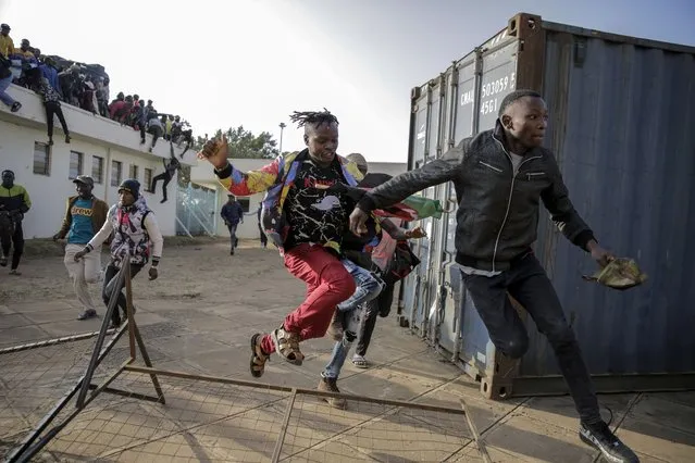 People break through barriers causing a stampede as they try to force their way into Kasarani stadium, where the inauguration of Kenya's new president William Ruto is due to take place later today, in Nairobi, Kenya Tuesday, September 13, 2022. (Photo by Brian Inganga/AP Photo)