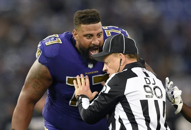 Baltimore Ravens offensive tackle Austin Howard, left, speaks with down judge Mike Spanier in the second half of an NFL football game against the Miami Dolphins, Thursday, October 26, 2017, in Baltimore. (Photo by Nick Wass/AP Photo)