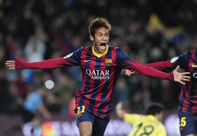 Barcelona's Brazilian forward Neymar da Silva Santos Junior (L) celebrates his second goal during the Spanish league football match FC Barcelona vs Villarreal CF at the Camp Nou stadium in Barcelona on December 14, 2013.   AFP PHOTO/ JOSEP LAGO        (Photo credit should read JOSEP LAGO/AFP/Getty Images)