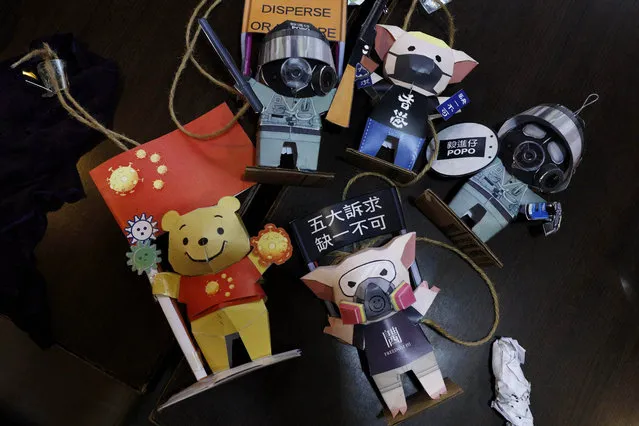 Paper figures of police officers, protesters and Winnie the Pooh, with messages in support of the pro-democracy movement are removed at a restaurant in Hong Kong, Thursday, July 2, 2020. Hong Kong police have made the first arrests under a new national security law imposed by mainland China, as thousands of people defied tear gas and pepper pellets to protest against it. Police say they arrested 10 people under the law, including at least one who was carrying a Hong Kong independence flag. (Photo by Kin Cheung/AP Photo)