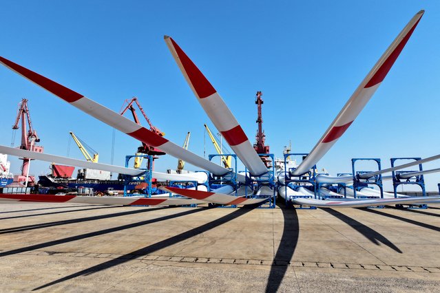 Goldwind wind turbine blades are seen on the dock waiting to be loaded onto a ship for export at the port in Lianyungang, in China's eastern Jiangsu province on March 17, 2025. (Photo by AFP Photo/China Stringer Network)