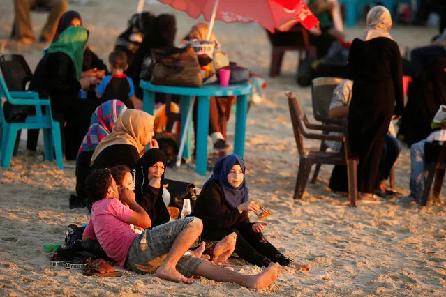 Palestinian family rests on a beach on a hot day in Gaza City July 19, 2016. (Photo by Suhaib Salem/Reuters)
