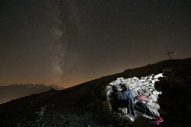 A photo made available 24 August 2016 shows two people looking at the milky way from the summit of the Grande Dent de Morcles (2,969m) above Morcles VD, Switzerland, 23 August 2016. (Photo by Anthony Anex/EPA)