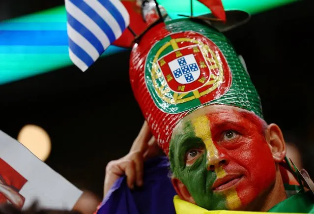 A Portugal fan, face painted in the colours of the national flag during the FIFA World Cup Qatar 2022 Group H match between Portugal and Uruguay at Lusail Stadium on November 28, 2022 in Lusail City, Qatar. (Photo by Kai Pfaffenbach/Reuters)