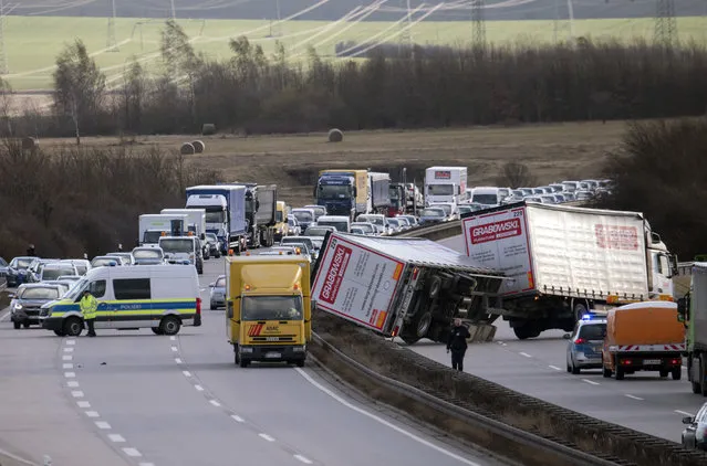 A truck crashed during heavy storms at the motorway A 71 near Erfurt, central Germany, Thursday, January 18, 2018. A powerful storm lashed Europe with high winds and snow, killing at least four people in three countries, grounding flights, halting trains, ripping roofs off buildings and flipping over trucks. (Photo by Jens Meyer/AP Photo)