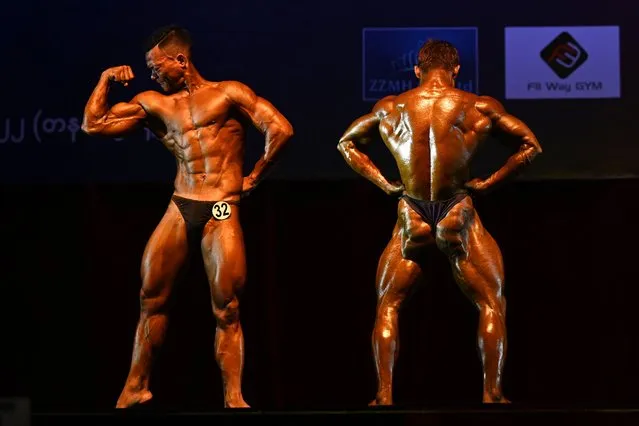 Bodybuilding athletes compete in the Myanmar National Championship Bodybuilding and Physique Sports Competition in Yangon on September 18, 2022. (Photo by Sai Aung Main/AFP Photo)