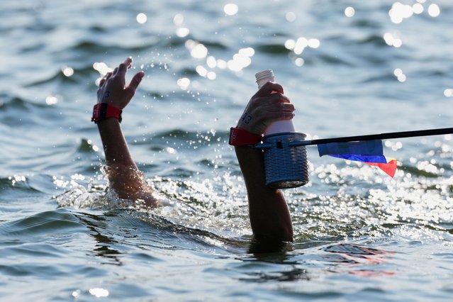 Alexandra Mejia Gallego of Andorra takes a drink during the women's 10km open water swim at the world swimming championships in Singapore, Wednesday, July 16, 2025. (Photo by Vincent Thian/AP Photo)