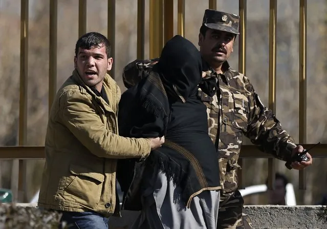 Security personnel arrest a suspect after a blast in Kabul, November 25, 2014. (Photo by Omar Sobhani/Reuters)