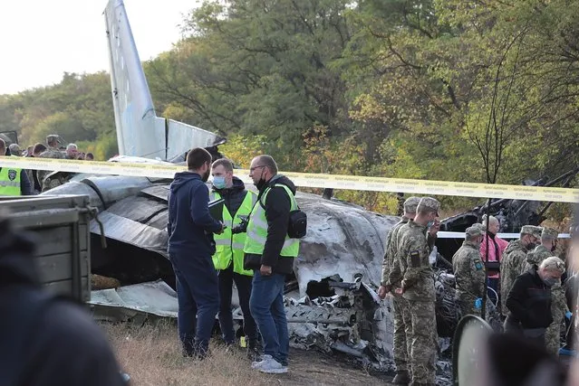 Rescuers inspect the crash site of the An-26 plane near of Chuguev city of Kharkiv's area, Ukraine, 26 September 2020. The An-26 plane of the Ukrainian Air Force crashed while landing at the Chuguev airport in Kharkiv region. Asides from the crew, 21 cadets of the Kharkiv National University of the Air Force were on board because it was a training flight according to preliminary information. A fire broke out during the plane crash. 22 people were killed, two were injured. A total of 28 persons were on board as local media report. (Photo by Sergey Khrupov/EPA/EFE/Rex Features/Shutterstock)