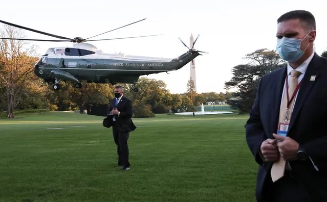 U.S. Secret Service agents stand at their posts as the Marine One helicopter with U.S. President Donald Trump onboard lifts off to depart the White House and fly to Walter Reed National Military Medical Center, where it was announced the president will stay for at least several days after testing positive for the coronavirus disease (COVID-19), on the South Lawn of the White House in Washington, U.S., October 2, 2020. (Photo by Leah Millis/Reuters)