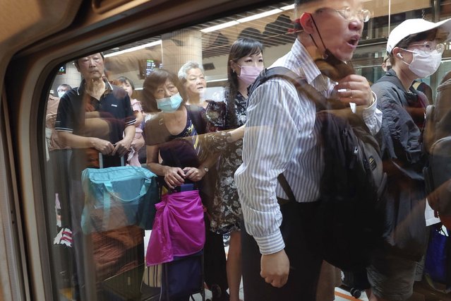 Passengers wait to board a south bound train as some train services were suspended in the aftermath of an earthquake in Taipei, Taiwan on Wednesday, April 3, 2024. Taiwan's strongest earthquake in a quarter century rocked the island during the morning rush Wednesday, damaging buildings and creating a tsunami that washed ashore on southern Japanese islands. (Photo by Chiang Ying-ying/AP Photo)