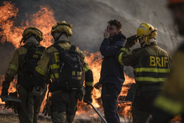 Firefighters try to control the flames during a forest fire in Monterrei, Ourense, Galicia, Spain, 13 August 2025. Multiple blazes continue to affect several provinces in Spain, after burning thousands of hectares across the country. (Photo by Brais Lorenzo/EPA)
