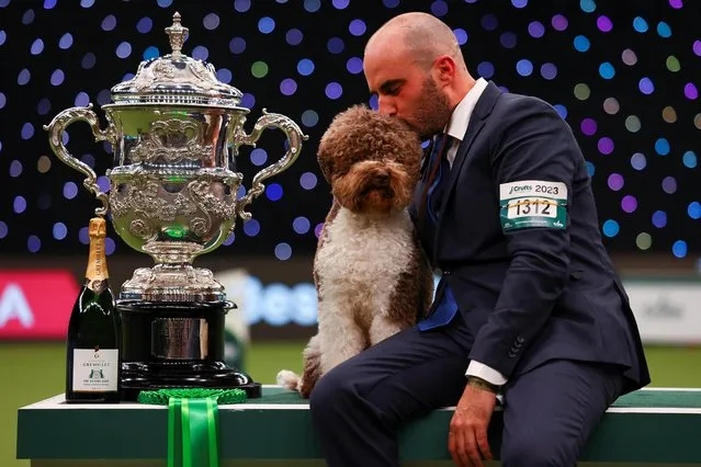 Handler Javier Gonzalez Mendikote and Lagotto Romagnolo named Orca celebrate after winning the best in show on the final day of the Crufts Dog Show in Birmingham, Britain on March 12, 2023. (Photo by Molly Darlington/Reuters)