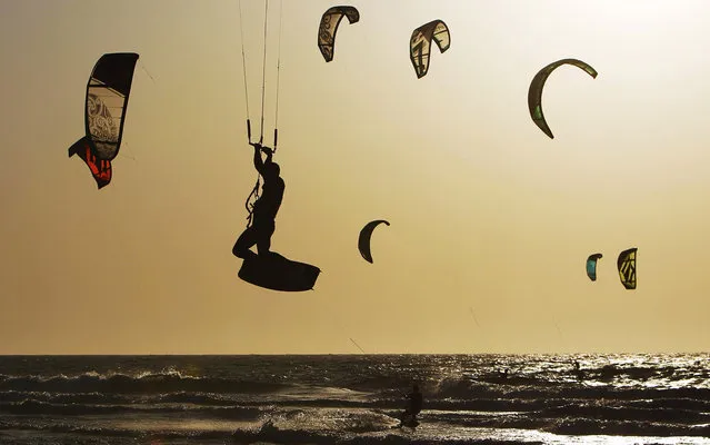 Kitesurfers revel in windy day on the beach of the Mediterranean Sea in Ashkelon, southern Israel, on April 25, 2013. (Photo by Amir Cohen/Reuters)