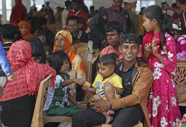 Rohingya refugees wait to be transported on a naval vessel to Bhashan Char, or floating island, in the Bay of Bengal, from Chittagong, Bangladesh, Friday, December 4, 2020. Authorities in Bangladesh on Friday started sending a first group of nearly more than 1,500 Rohingya refugees to an isolated island despite calls by human rights groups for a halt to the process. (Photo by AP Photo/Stringer)