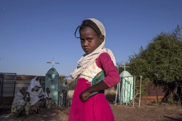 A Tigrayan girl who fled the conflict in Ethiopia's Tigray region, prepares to leave after Sunday Mass ends at a church, near Umm Rakouba refugee camp in Qadarif, eastern Sudan, November 29, 2020. (Photo by Nariman El-Mofty/AP Photo)