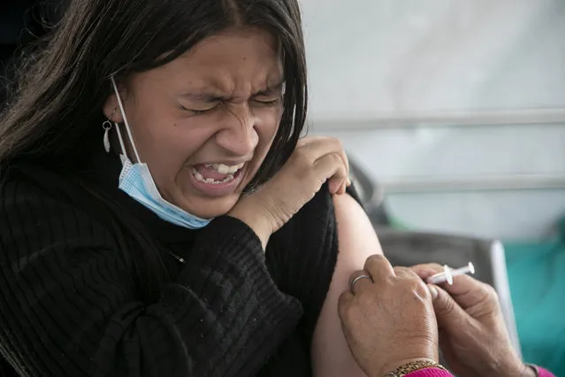 A girl reacts as she receives a shot of the Pfizer-BioNTech vaccine for COVID-19 in Kathmandu, Nepal, Tuesday, November 23, 2021. Children above the age of 12 are now receiving the vaccine in Nepal. The World Health Organization downgraded its assessment of the coronavirus pandemic on Friday, May 5, 2023, saying it no longer qualifies as a global emergency. (Photo by Niranjan Shrestha/AP Photo)