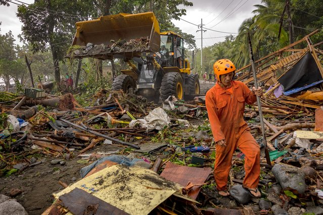 A bulldozer is used to clear debris from a highway brought about by Super Typhoon Fung-wong on November 10, 2025 in Dipaculao, Aurora province, Philippines. (Photo by Ezra Acayan/Getty Images)