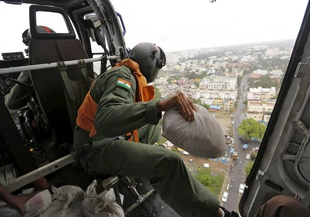 An Indian coast guard personnel prepares to drop relief materials in a flood-affected area in Chennai, India, December 6, 2015. (Photo by Anindito Mukherjee/Reuters)