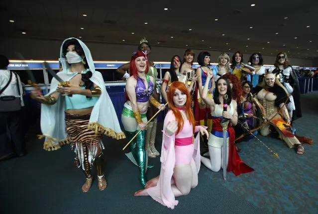 Attendees wearing costumes pose for a photo during Comic-Con international convention in San Diego, California July 13, 2012. (Photo by Mario Anzuoni/Reuters)