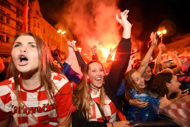 Croatia' s supporters celebrate after a goal as they watch on a giant screen the Russia 2018 World Cup semi- final football match between Croatia and England, at the main square in Zagreb on July 11, 2018. (Photo by Denis Lovrovic/AFP Photo)