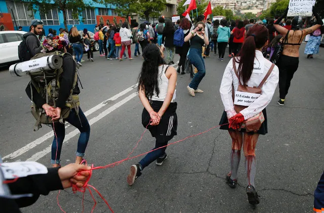 Members of feminist organisations take part in a rally against gender violence on the International Day for the Elimination of Violence Against Women, in Valparaiso, Chile, November 25, 2016. (Photo by Rodrigo Garrido/Reuters)