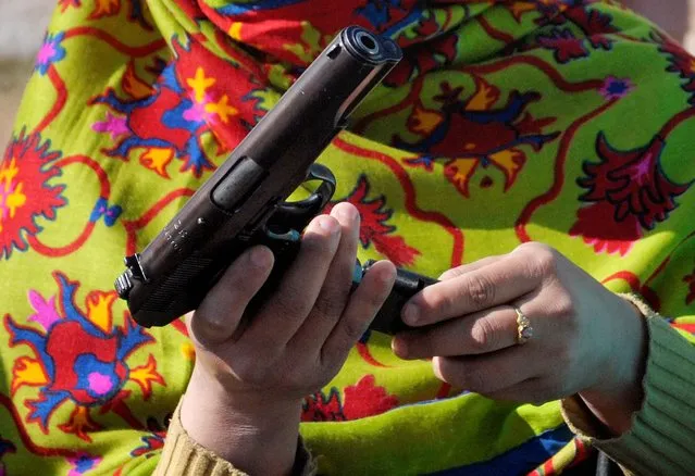 In this Tuesday, January 27, 2015 photo, a Pakistani teacher learns to load a pistol during a two-day weapons training session in Peshawar, Pakistan. When Pakistani Taliban militants stormed a Peshawar school on Dec. 16, 2014 and massacred 150 children and teachers, nobody could fight back. (Photo by Mohammad Sajjad/AP Photo)