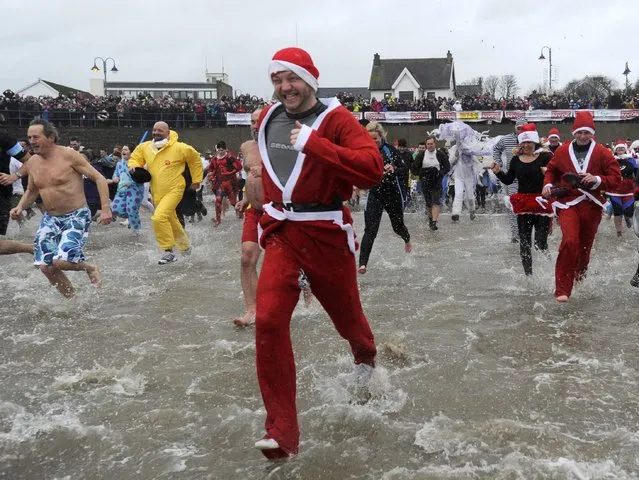 Swimmers in fancy dress participate in the New Year's Day swim at Saundersfoot in south Wales, Britain January 1, 2016. (Photo by Rebecca Naden/Reuters)