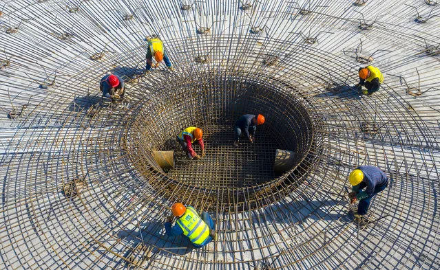 Workers work on a sewage collection and treatment tank in Suqian, east China's Jiangsu Province, April 29, 2021. (Photo credit should read Costfoto/Barcroft Media via Getty Images)