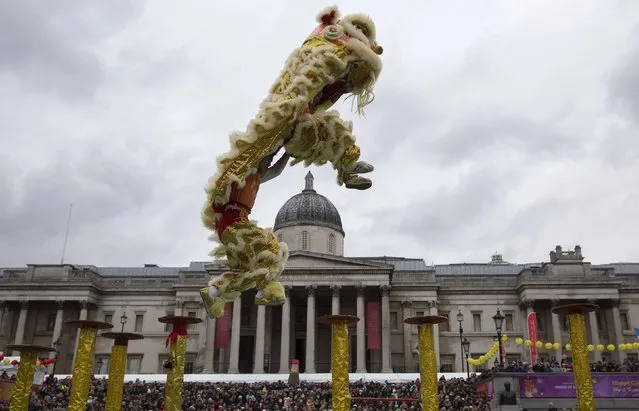 Performers dressed in traditional costume perform the “flying lion dance” to celebrate the Chinese New Year at Trafalgar Square in London, February 22, 2015. (Photo by Neil Hall/Reuters)