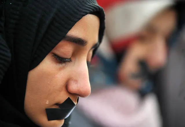 A Bosnian Muslim woman cries as several thousands of Bosnian protestors gather to raise their voice against the killing in eastern Aleppo, Syria, during a rally in Sarajevo, on December 14, 2016. The seige of Aleppo is brutal but far from unprecedented, with the Bosnian capital Sarajevo and Chechnya's regional capital Grozny previously subjected to devastating bombardments. (Photo by Elvis Barukcic/AFP Photo)