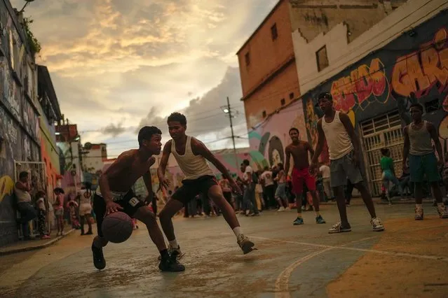 Youths play a pick-up game of basketball in the San Agustin neighborhood of Caracas, Venezuela, Sunday, August 27, 2023. (Photo by Matias Delacroix/AP Photo)