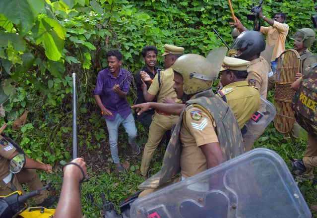 Police wield their batons against demonstrators during a protest against the lifting of a ban by Supreme Court that allowed entry of women of menstruating age to the Sabarimala temple, at the Nilakkal Base Camp in Pathanamthitta district in the southern state of Kerala, October 17, 2018. (Photo by Reuters/Stringer)