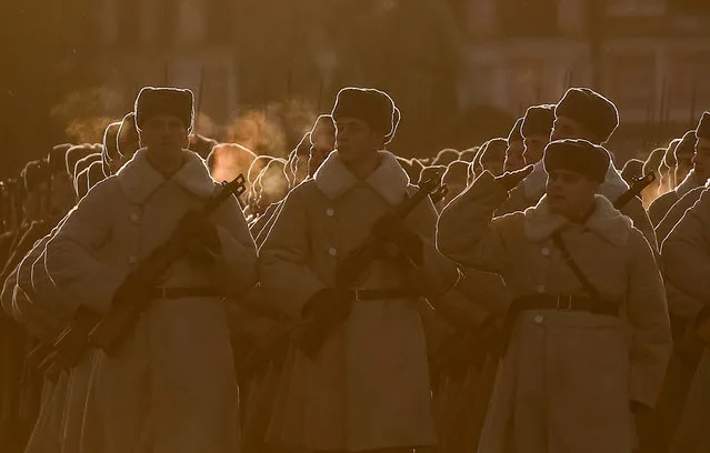 Russian Army members, dressed in historical uniforms, take part in a rehearsal for a military parade to mark the anniversary of a historical parade in 1941, when Soviet soldiers marched towards the front lines, at the Red Square in Moscow, Russia November 5, 2018. (Photo by Maxim Shemetov/Reuters)