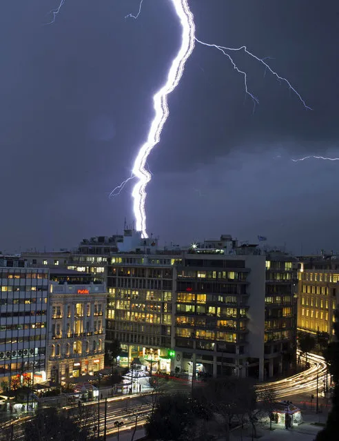 Lightning strikes over buildings at central Syntagma square during heavy rainfall in Athens January 26, 2015. (Photo by Marko Djurica/Reuters)