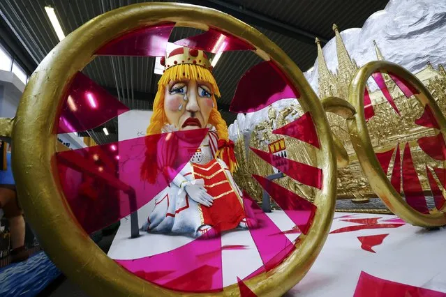 A papier mache figure of the “Cologne Virgin”, a member of the traditional Cologne carnival triumvirate, crying through broken rose-coloured glasses, is prepared for the upcoming Rose Monday carnival parade in Cologne, Germany February 2, 2016. (Photo by Wolfgang Rattay/Reuters)