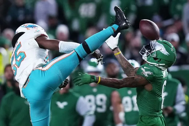 Philadelphia Eagles wide receiver DeVonta Smith (6) reaches for the ball in front of Miami Dolphins linebacker Jerome Baker (55) during the first half of an NFL football game Sunday, October 22, 2023, in Philadelphia. Smith makes the catch. (Photo by Matt Rourke/AP Photo)