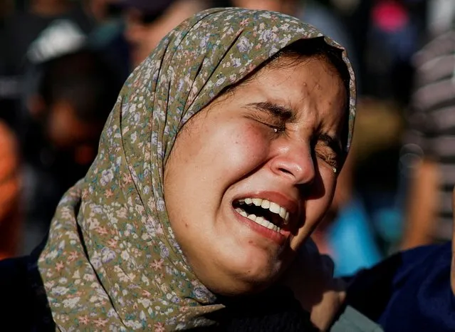 A woman mourns during a funeral for Palestinians killed by Israeli strikes, as the conflict between Israel and Palestinian Islamist group Hamas continues, in Khan Younis in the southern Gaza Strip on October 26, 2023. (Photo by Mohammed Salem/Reuters)