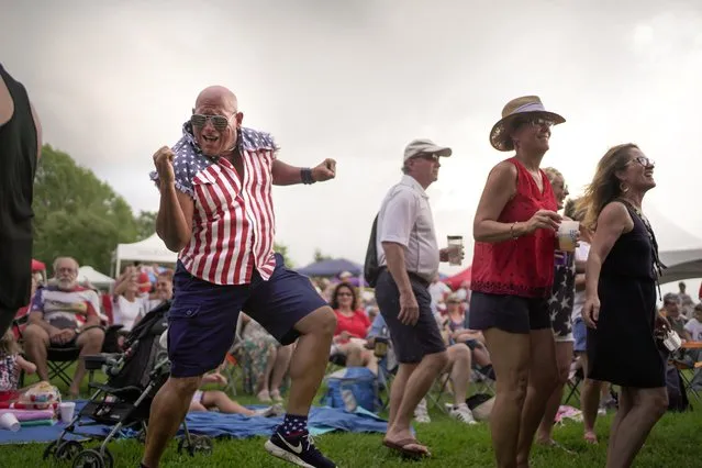 Billy Klaus, of Hammond, dances during the Light up the Lake Independence Day Celebration at the Mandeville Lakefront in Mandeville, Louisiana, U.S., July 4, 2021. (Photo by Kathleen Flynn/Reuters)