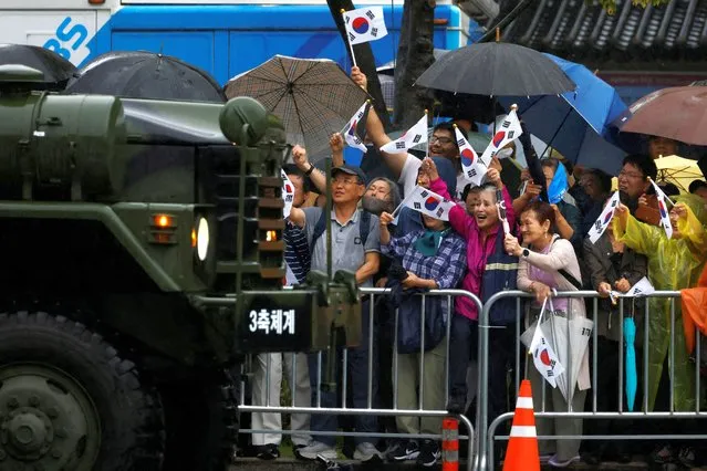 People react as they watch a military parade to mark the 75th anniversary of South Korea's armed forces, the first such large scale parade through the capital city in 10 years, in Seoul, South Korea on September 26, 2023. (Photo by Kim Soo-hyeon/Reuters)